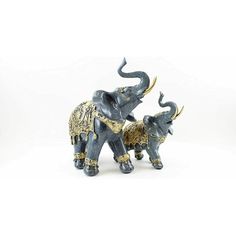 an elephant figurine with two smaller elephants standing next to each other on a white background