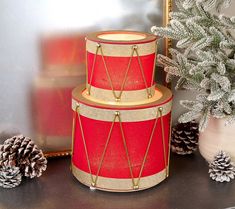 two red and gold cakes sitting on top of a table