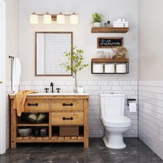 a white toilet sitting next to a wooden sink vanity in a bathroom under a mirror