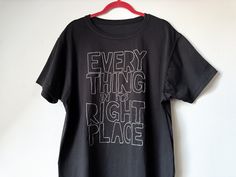 a black t - shirt that says every thing is right place