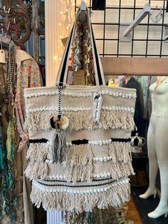 Jet set in style with this 00A7 Miami fringe tote bag! Get ready to turn heads with its natural color, playful tassels, and fashion-forward look. Feel like a celeb while you trot around town for the ultimate travel get away! Chic Tote Shoulder Bag With Fringe, Chic Fringe Tote Shoulder Bag, Chic Travel Shoulder Bag With Fringe, Chic Fringe Shoulder Bag For Travel, Chic Travel Bag With Fringe, Chic Tote Shoulder Bag With Tassels, Chic Tassel Tote Shoulder Bag, Trendy Fringe Shoulder Bag For Summer, Trendy Beige Shoulder Bag With Fringe