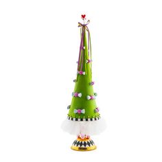 a small green christmas tree with bows on it's head and tulle skirt