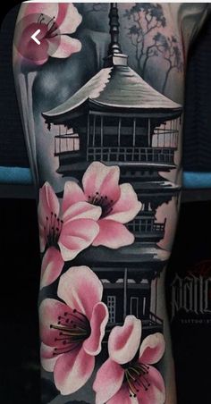 a tattoo with flowers on it and a pagoda in the background, is shown here