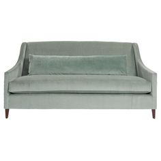 a light blue couch with two pillows on it's back and one arm folded