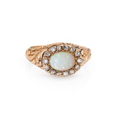 Stylish antique Victorian era ring (circa 1880s to 1900s), crafted in 14 karat yellow gold. One opal measures 7mm x 5mm, accented with 14 estimated 0.02 carat old rose cut diamonds. The total diamond weight is estimated at 0.28 carats (estimated at I-J color and I1-2 clarity). The opal is in very good condition and free of cracks or chips. Set in an east to west design, the opal is surrounded with old rose cut diamonds that offer a subtle shimmer. Intricate etched foliate details adorn the side shoulders. The ring has a low profile and rises 6mm from the finger (0.23 inches). The ring is in good condition. We have not cleaned it in order to preserve the patina and collector value.     Particulars: Weight: 4.1 grams Stones:  One opal measures 7mm x 5mm, accented with 14 estimated 0.02 carat Masonic Jewelry, Russian Jewelry, Opal Diamond Ring, Antique Jewelry Rings, Victorian Ring, Nouveau Jewelry, Jewelry Mens, Old Rose, Victorian Rings