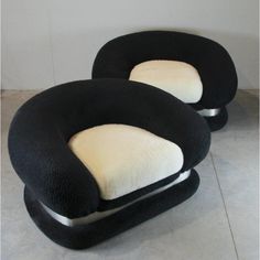 two black and white chairs sitting next to each other