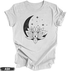 Elevate your everyday boho style with our unisex crew neck t-shirt, featuring a lotus flower with a crescent moon and stars illustration. This shirt seamlessly blends comfort and fashion making it the perfect addition to your wardrobe for any occasion. This trendy celestial graphic will be printed on a Bella+Canvas Unisex Tee. Order your regular size for a slim fit and size up for a more roomy fit. Please refer to the size chart in the images for the best fit. This classic unisex jersey short sl Bohemian Short Sleeve T-shirt With Moon Print, Bohemian Short Sleeve Tops With Moon Print, Bohemian Cotton T-shirt With Moon Print, Bohemian Tops With Moon Print Relaxed Fit, Moon And Stars Illustration, Stars Illustration, Celestial Shirt, Spiritual Shirts, Star Illustration