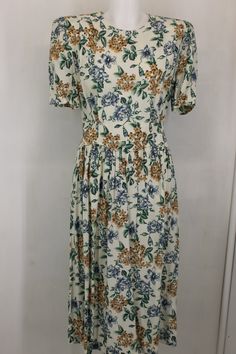 Vintage karin stevens women's floral dress size 14p color green/blue/tan/ivory. short sleeve, sholder pad, back zipper, elastic band. armpit to apmpit -21''. waist- 29'' stretching to 36''. top to bottom-46''. thank you! Casual Cream Floral Print Dress, Cream Short Sleeve Dresses With Floral Print, Cream Fitted Floral Short Sleeve Dress, Cream Floral Print Dresses With Short Sleeves, Cream Short Sleeve Floral Dress For Garden Party, Cream Floral Short Sleeve Dress For Garden Party, Beige Floral Print Short Sleeve Dress, Beige Floral Print Dress With Short Sleeves, Beige Floral Dress With Short Sleeves