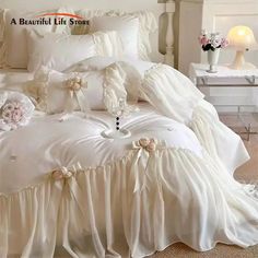 a white bed with ruffles and flowers on it's comforter in a bedroom