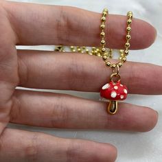 "So cute! You'll look so adorable with this red and gold plated mushroom charm pendant necklace. Perfect for nature lovers, cottagecore girls, mushroom lovers and more. Choose your own necklace length from 14\", 16\", 18\" or 20\" for Gold Plated Mushroom Necklace. Charm hangs from a perfect 14k gold plated dainty chain. Chains are high quality gold plating and tarnish resistant. Gold and red enamel with CZ stones.  Necklace comes with 14k gold plated chain 14k gold plated over stainless steal - Nickel and lead free Please chose your chain length preference options available: 14\" (fits like a choker), 16\" (standard necklace length), 18\", 20\" Bring a touch of nature to your wardrobe with this beautiful 14k Gold Plated Red and Gold Mushroom Charm Necklace. Crafted with high-quality mater Brown Mushroom Necklace, Cute Mushroom Design Dangle Jewelry, Red Mushroom Design Jewelry Gift, Mushroom Design Dangle Jewelry Gift, Mushroom Design Dangle Jewelry As Gift, Gold Mushroom Pendant Necklace, Mushroom Shaped Necklace For Gifts, Mushroom Design Necklace Gift, Mushroom Design Necklace As Gift