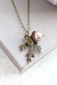 This is a beautiful nature inspired charm necklace! The charm cluster pendant includes a 12mm chocolate brown Swarovski pearl acorn with rustic antiqued brass top, an antiqued gold pine cone with gorgeous details and a woodland branch of three leaves in antique gold brass. The chain length is available in 16" - 26" length. You can select from 15 pearl colors. This necklace will be shipped on a branded necklace display card Wedding Nature, Wedding Autumn, Jewelry Layering, Acorn Necklace, Branch Necklace, Gold Bridesmaids, Red Pearl, Nature Necklace, Wedding Winter