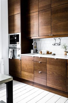 a kitchen with wooden cabinets and white counter tops