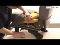 a man is using a machine to cut up the bottom part of a piece of furniture