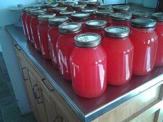 many red jars are lined up on the counter