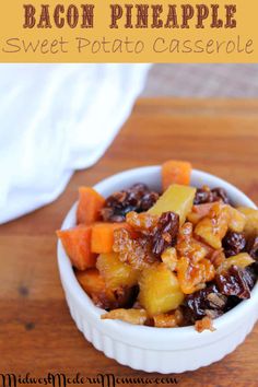 sweet potato casserole with raisins and pineapple in a white bowl