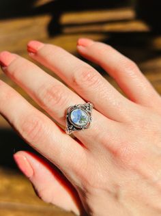 Gorgeous antique style silver plated ring with real forget me not flowers. The flowers are delicately placed against a white background and preserved in resin. PLEASE KNOW YOUR SIZE. I do not accept exchanges or returns.  ❌DisclaimerAll flowers are different from one another. That's nature. I do my best to pair up flowers of similar color and shape for each pair of earrings. Same with rings.Some pieces may tarnish with time. That's why a jewelry cloth is included with every purchase. I do my best to make the resin as clear as possible. With that being said, you are likely to spot some air bubbles within each piece. It just makes each piece that much more unique! Unless otherwise stated in the listing, there's no guarantee you will get the exact item pictured. Again, all flowers are differe Delicate Silver Opal Ring In Sterling Silver, Vintage Handmade Silver Opal Ring, Handmade Vintage Silver Opal Ring, Handmade Silver Vintage Opal Ring, Vintage Silver Opal Promise Ring, Dainty Handmade Silver Opal Ring, Vintage Silver Jewelry With Pressed Flowers, Forget Me Not Ring, Botanical Ring