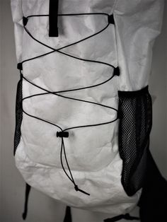 a white bag with black string attached to it