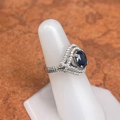 Estate/ vintage 14KT white gold oval, blue sapphire + diamond double halo ring. Scroll, double rowed, pave set, diamonds that follow the shape of the oval in an almost halo. Size 6 Can be resized for an additional fee Weight: 5.1 grams Design Split Double Halo with 114 round diamonds .82 carat total weight diamonds SI clarity, H color diamonds 1.82 carat faceted oval sapphire measures: 8mm x 6mm Genuine, oval cut, medium-dark blue sapphire Excellent estate condition Some very light abrasions to Oval Sapphire Ring With Pave Setting, Classic Oval Sapphire Ring With Pave Setting, Oval Sapphire Ring With Pave Setting For Anniversary, Oval Blue Diamond Ring With Pave Setting, Double Halo Ring, Double Diamond, Blue Sapphire Diamond, Double Halo, Halo Diamond Ring