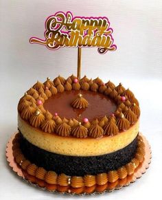 a happy birthday cake with chocolate frosting and decorations on top is shown in front of a white background