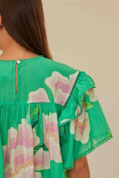 Embrace the vibrancy of the season with the Green Floral Vibing Blouse, a lively symphony of bright green hues and whimsical floral prints. This alluring piece features a round neckline complemented by fluttering ruffle sleeves and a delicate trim. The soft, flowing cut creates a playful yet refined silhouette that dances with each step. Perfect for infusing your wardrobe with a touch of tropical charm and effortless elegance. Composition 100% COTTONCare Instructions MACHINE WASH DELICATE CYCLE, DO NOT BLEACH, DO NOT TUMBLE DRY, LINE DRYING, IRON AT MEDIUM HEAT, DRY CLEAN WITH ANY SOLVENT EXCEPT TRICHLOROETHYLENESize and Fit Inches XXS XS S M L XL Bust 41 3/4 43 3/4 45 3/4 47 3/4 50 3/4 54 Waist 39 3/4 40 3/4 41 3/4 42 3/4 44 1/4 45 3/4 Length 20 20 3/4 21 1/4 21 3/4 22 2/4 23 Hip N/A N/A Jean Romper, Rio Brazil, Lavender Brown, Diff Eyewear, Cami Nyc, Ronny Kobo, Printed Dresses, Tony Bianco, Solid & Striped