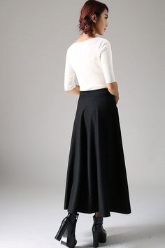 "Look elegant and stylish at all times and for any occasion in this long black classical A-line skirt. This flared women skirt with double stitching detail at hip pockets oozes understated sophistication. This very versatile winter skirt can be worn casually with knitwear or more formally with a crisp white blouse.This is a timeless investment piece you'll have in your wardrobe for years to come. Choosing black makes it so easy to pair with a variety of blouses and jackets. Scientific studies ha Chic A-line Wool Bottoms, Classic A-line Maxi Skirt For Formal Occasions, Black A-line Maxi Skirt For Winter, Elegant A-line Bottoms For Winter, Elegant Skirt With Wide Hem, Elegant Flowy Skirt With Wide Hem, Elegant Fall Skirt With Wide Hem, Fall Wide Hem Lined Skirt, Elegant Bottoms With Lined Skirt And Wide Hem