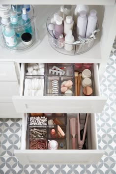 an organized drawer in a bathroom with toiletries and other items on the drawers,