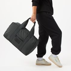 This sleek, lightweight, and durable duffle, crafted from ripstop nylon, seamlessly blends style with functionality. Become a carry-on pro with the built-in trolley sleeve that lets you secure the duffle to your luggage for effortless airport navigation. Keep essentials organized with pockets and carry comfortably with padded handles. | Keep It Light Weekender in Black Monochrome | by ALOHA Collection Sporty Black Luggage For On-the-go, Functional Duffle Bag With Luggage Sleeve For On-the-go, Sporty Large Capacity Luggage For On-the-go, Large Capacity Sporty Luggage, Casual On-the-go Duffle Bag With Luggage Sleeve, Sporty Nylon Luggage For On-the-go, Sporty Rectangular Luggage For Everyday Use, Sporty Rectangular Luggage For Weekend Trips, Sporty Rectangular Travel Luggage