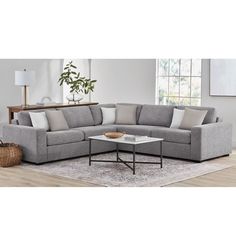 a living room with a sectional couch and coffee table