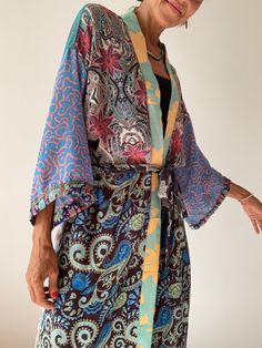 Boho style long patchwork robe always one of a kind made of varieties of silky colourful materials with different floral prints it can be worn on its own as a daily cover up or layered over a t shirt and jeans very easy to wear and comfy with pockets and tiny side splits  length 55" more available at  https://www.etsy.com/shop/AltheaStores? Thank you for looking Multicolor Long One-size Kimono, Bohemian Multicolor Robe For Festivals, Hippie Multicolor Open Front Kimono, Bohemian Long Patchwork Kimono, Hippie Style Multicolor Wrap Kimono, Hippie Multicolor Wrap Kimono, Bohemian Multicolor Silk Kimono, Bohemian Multicolor Patterned Kimono, Bohemian Patterned Multicolor Kimono