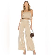 Lovers + Friends Zoey Wide Leg Pants Metallic Gold Cocktail Party Glam Xs New. New Lovers + Friends Zoey Wide Leg Pants In Light Gold. Metallic Finish. High Waist With Hidden Side Zipper Closure. Marked Size Xs. A Flowing Length Of Luminous Fabric And A Dash Of Fluttery Movement Transforms These Wide-Leg Pants Into Night-Out Gold. Side Zip Closure Lined 67% Rayon, 33% Nylon Hand Wash, Dry Flat Waist - Approx. 11" Flat Hips - Approx. 16" Flat Length - 43" Inseam - 32" Rise - 12" Nwt. Tag May Have Summer Party Jumpsuit With High-waisted Pants, Summer Wide-leg Pantsuit For Party, Summer Evening High-waisted Pantsuit, Chic High Waist Pant Set For Summer, Chic Party Sets With High-waisted Pants, Glamorous Summer Night Out Pants, Glamorous Summer Pants For Night Out, Summer Party Sets With High-waisted Pants, Glamorous Summer Evening Wide Leg Pants