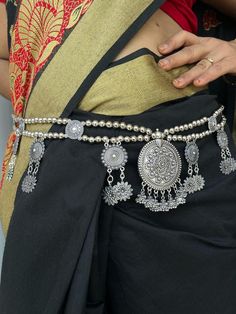 Oxidized silver kamarpatta waistbelt waist chain for women. The look is stunning and preciously suitable for all kinds of dressy occasions. The kamarband for women wedding is an amazing ethnic jewelry collection is ideal for wedding and also for all other traditional, casual and regular occasions that will add class and style to your look. A perfect gift for your daughter, mother, sister, friend, fiancée or bride. Silver-plated Light weight waist belt for your comfort. Trendy & Latest fashion. A Silver Bohemian Body Chain For Festivals, Bohemian Silver Waist Chain As Gift, Bohemian Silver Body Chain As Gift, Bohemian Silver Body Chain For Wedding, Elegant Silver Chain Belt For Festival, Traditional Waist Chain With Latkans For Festivals, Silver Bohemian Chain Belt For Festivals, Silver Bohemian Waist Chain For Festivals, Bohemian Silver Waist Chain For Festivals