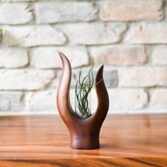 Bring yourself close to nature with this modern yet rustic artistry. Working in natural wood, Thai artisan ping meticulously crafts this rustic wooden plant vase with the amazing wood process in unique colors and textures on the surface. This exceptional piece is produced from natural mango wood with a tube glass vase or holder perfect for propagating, cuttings, and versatile flower arrangement. Bring an accent of originality and the art of nature to your interior design that will definitely enh Water Propagation, Mango Tree, Table Designs, Wooden Vase, Plant Vase, Table Vase, Propagating Plants, Table Vases, Wood Stand