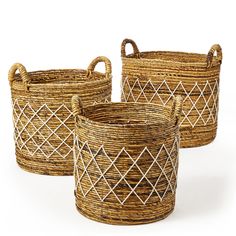 three woven baskets with handles on white background