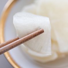 chopsticks sticking out of a bowl filled with sugar