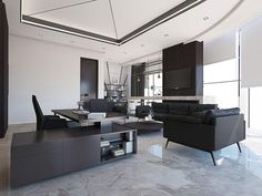 a modern living room with black furniture and white walls, along with marble flooring