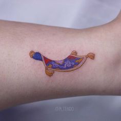 a small tattoo on the arm of a woman