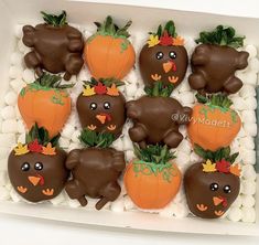 chocolate covered strawberries in the shape of animals and pumpkins with leaves on them