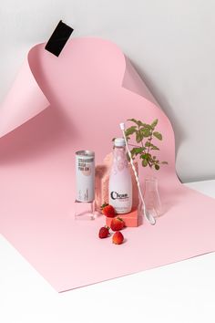 a pink background with strawberries and other items