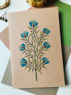 a card with an image of blue flowers on it next to some scissors and other crafting supplies