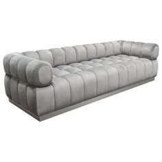 a large gray couch sitting on top of a white floor