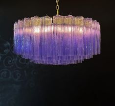 a purple chandelier hanging from a ceiling