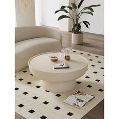 a white coffee table sitting on top of a rug