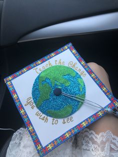 a person is holding a card with the earth on it that says touch the climate you wish to see