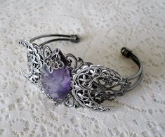 This beautiful silver plated cuff bracelet has a silver plated triple moon design and an amethyst setting with silver plated embellishments. Adjustable. Bohemian Hand Cast Metal Bracelets, Hand Cast Metal Bohemian Bracelets, Spiritual Silver Crystal Bracelet For Wedding, Gothic Adjustable Bracelet, Spiritual Hand Cast Bracelet Jewelry, Gothic Bangle Bracelet For Gift, Spiritual Hand Cast Jewelry Bracelet, Spiritual Hand-cast Bracelet Jewelry, Adjustable Gothic Bracelet