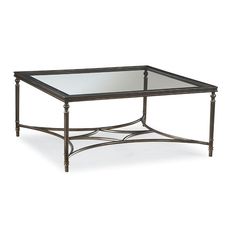 a coffee table with glass top and metal frame