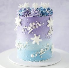 there is a blue and purple cake with flowers on it