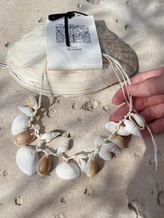 Embrace the essence of the ocean with our Boho Seashell Choker Necklace—an exquisite accessory for beach lovers and free spirits alike. Perfect for your next beach vacation, a seaside wedding, or simply adding a touch of coastal charm to your everyday look, this necklace captures the beauty of the sea in a minimalist, boho-inspired design. Handcrafted with natural seashells, each choker is a unique piece of ocean treasure that resonates with the tranquil vibes of the beach. Its simple yet elegan Beachy Strand Jewelry For Beach Party, Beachy Jewelry For Beach Party, Beach Party Beachy Strand Jewelry, Ocean-inspired Strand Jewelry For Beach Party, Ocean-inspired Jewelry For Beach Party, Handmade Summer Jewelry For Beach Wedding, Ocean-inspired Jewelry For Vacation, Strand Jewelry For Beach Party, Adjustable Ocean-inspired Necklace