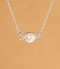 Moonstone necklace - silver moonstone - june birthstone - rainbow moonstone - a silver bezel set moonstone on a sterling silver chain A beautiful, one of a kind, silver lined rainbow moonstone, hanging horizontally from a 16 inch sterling silver chain. Please feel free to select a different length chain if you prefer! I took multiple photos in different light to show all the possible colors of this gem. Moonstones reflect at different angles and all sorts of light. Need a few reasons to love a m White Sterling Silver Necklace With Moon Charm, White Moonstone Necklace With Delicate Chain, Delicate Silver Necklace With Bezel Setting, Delicate Silver Bezel Setting Necklace, White Moonstone Necklace With Adjustable Chain, Dainty White Moonstone Necklace, Dainty White Birthstone Necklace, White Delicate Birthstone Necklace, Delicate White Birthstone Necklace