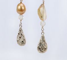 Asymmetrical, gold drop earrings begin with our vanilla beans, continue with citrine, layer on golden freshwater pearls, and end with intricately textured gold leaves. All gold is 14kt yellow. An approximate 4" drop. Gold Briolette Earrings For Formal Occasions, Gold Briolette Pearl Earrings For Formal Occasions, Gold High Luster Pearl Earrings For Evening, High Luster Gold Pearl Earrings For Evening, Handmade Gold Briolette Pearl Earrings, Gold Briolette Pearl Earrings With High Luster, Gold Briolette Pearl Earrings, Citrine Drop Earrings For Wedding, Elegant Drop Citrine Earrings