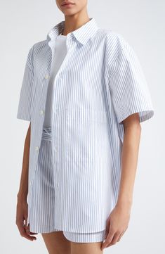 Allover stripes enliven this polished poplin shirt crafted in a longline silhouette with elbow-length sleeves. 31" length (size 38) Front button closure Spread collar Elbow-length sleeves 100% cotton Dry clean or machine wash, line dry Made in Portugal Button-up Shirt With Signature Stripes For Work, Workwear Button-up Shirt With Signature Stripes, Vertical Stripes Shirt For Summer Workwear, Modern Striped Shirt For Spring, Spring Workwear Top With Signature Stripes, Elbow Length Sleeve, Poplin Shirt, Striped Shorts, Long A Line